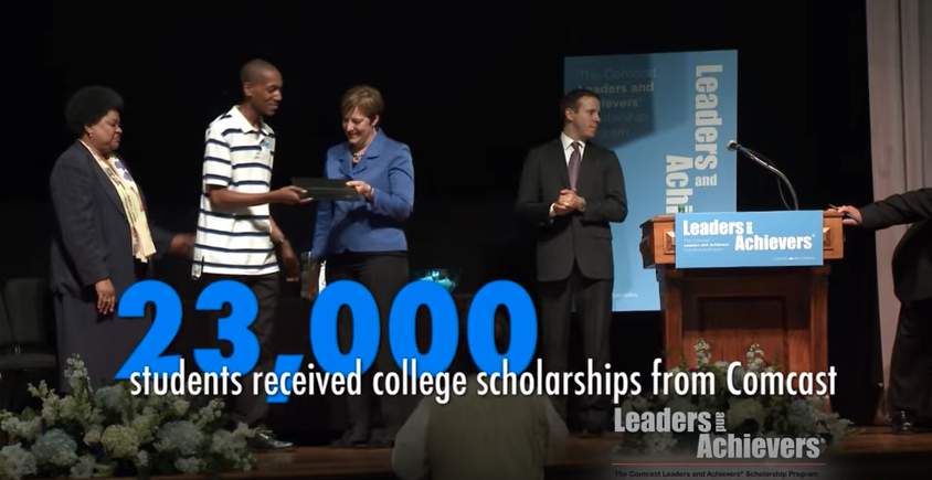 Students onstage receiving scholarships onstage during a Leaders and Achievers event.