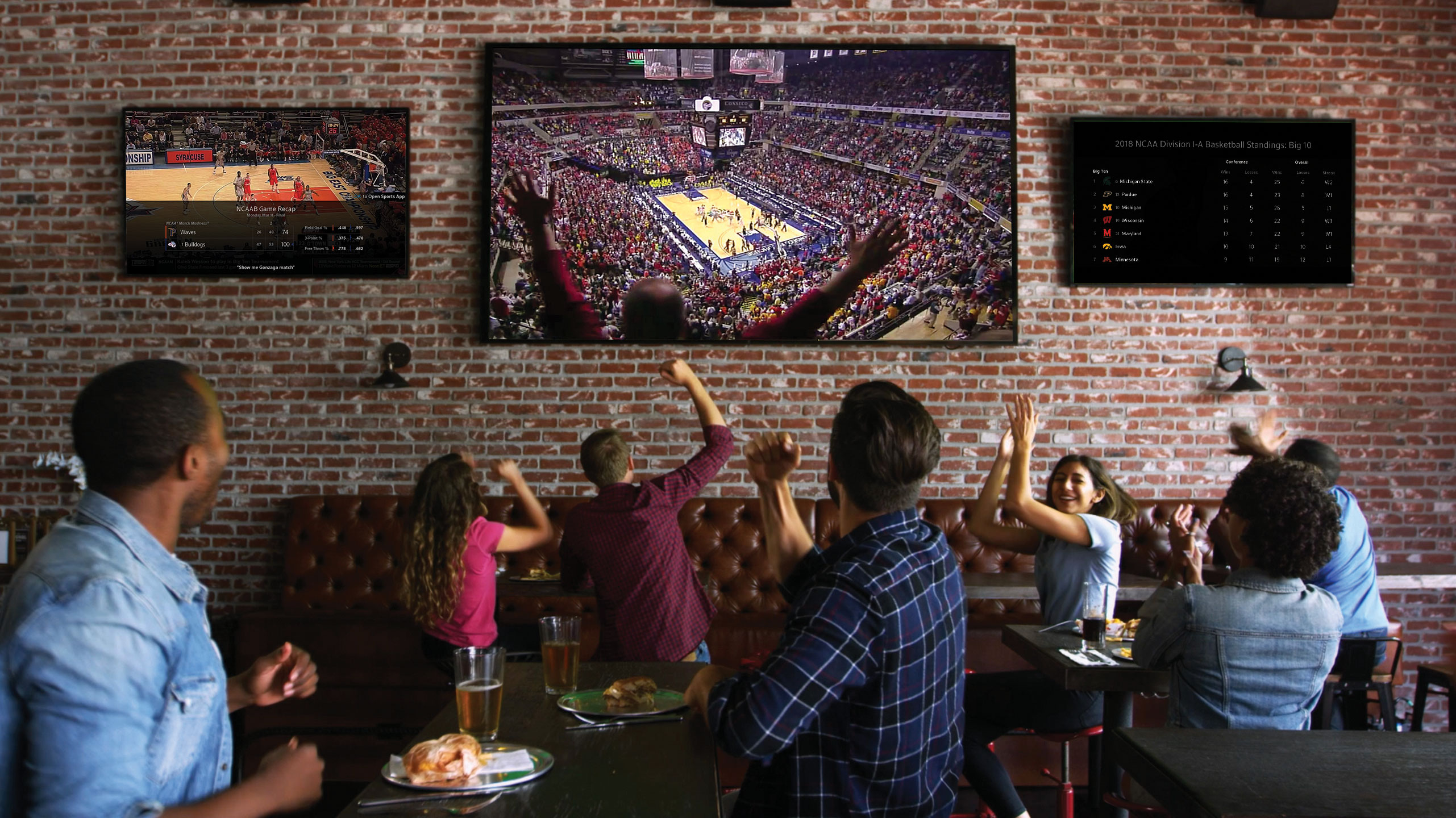 group of people watching tv at a restaurant