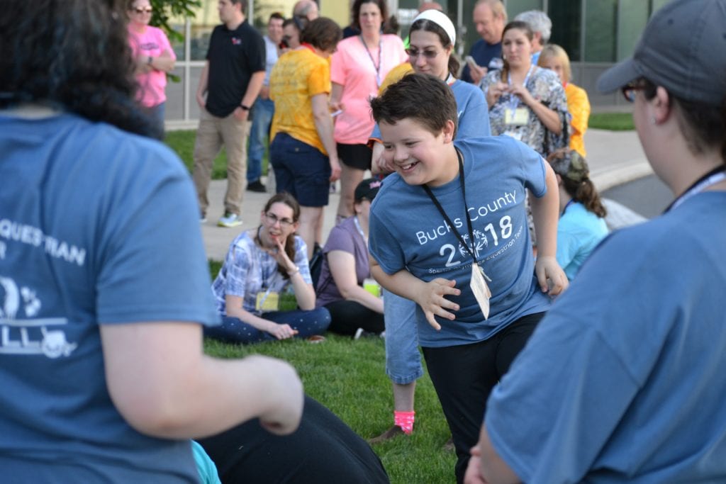 Special Olympics athlete running in a relay race