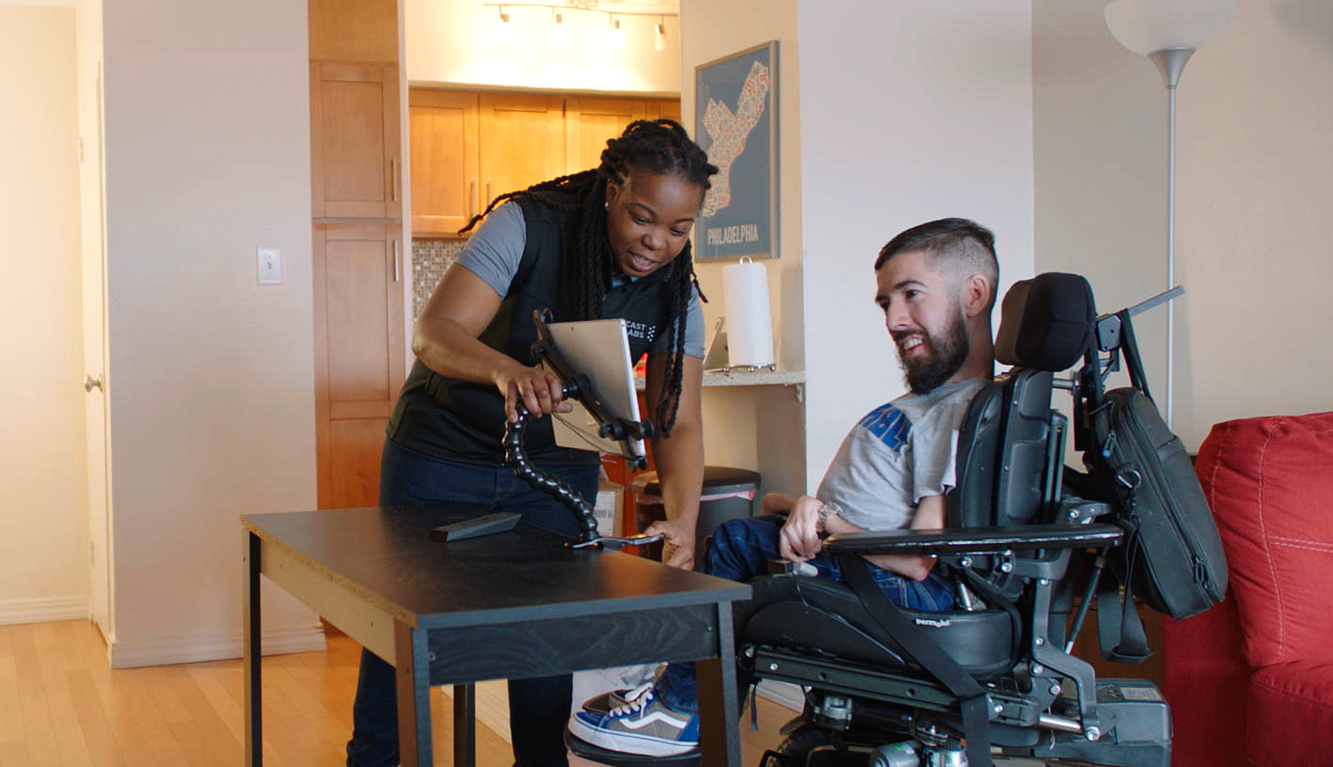 Xfinity employee helping a disabled man with eye control