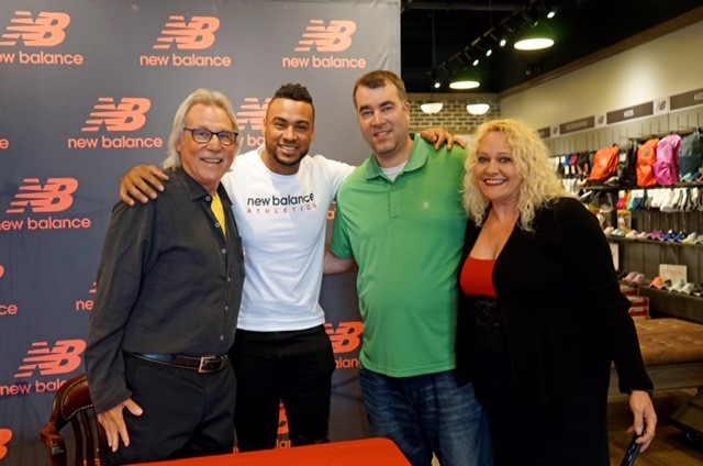 Elias Diaz with Comcast employees at autograph signing event