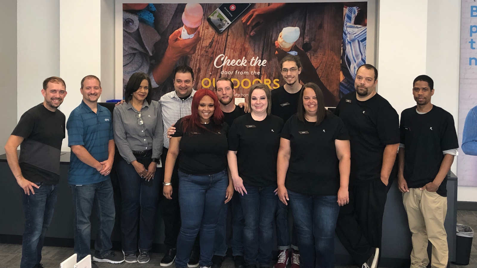 Large group of employees inside Xfinity store.