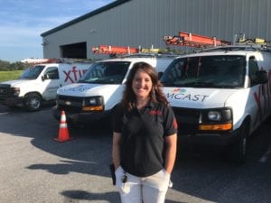 Woman smiling in front of her truck