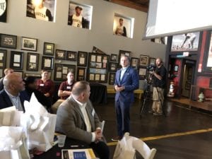 Speaker talking to a group sitting inside a museum