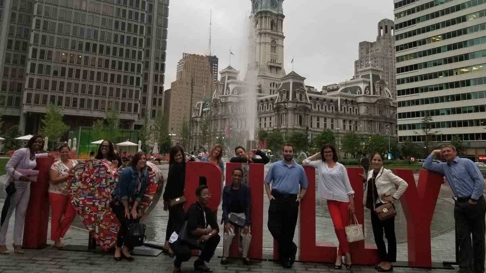 Comcast employees standing together in a Philadelphia park.