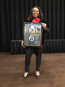 Toni Murphy, holding a plaque