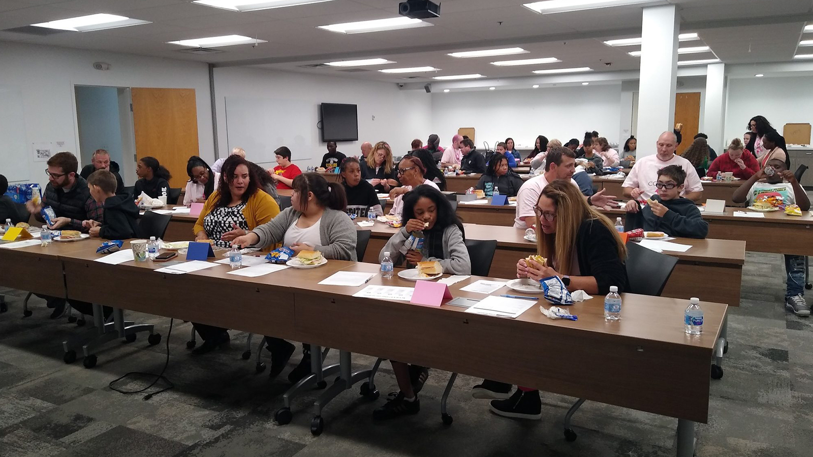 Comcast employees with their Littles in a conference room.