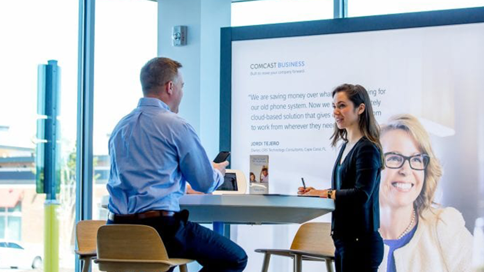 Customer in a Comcast store talking about business solutions