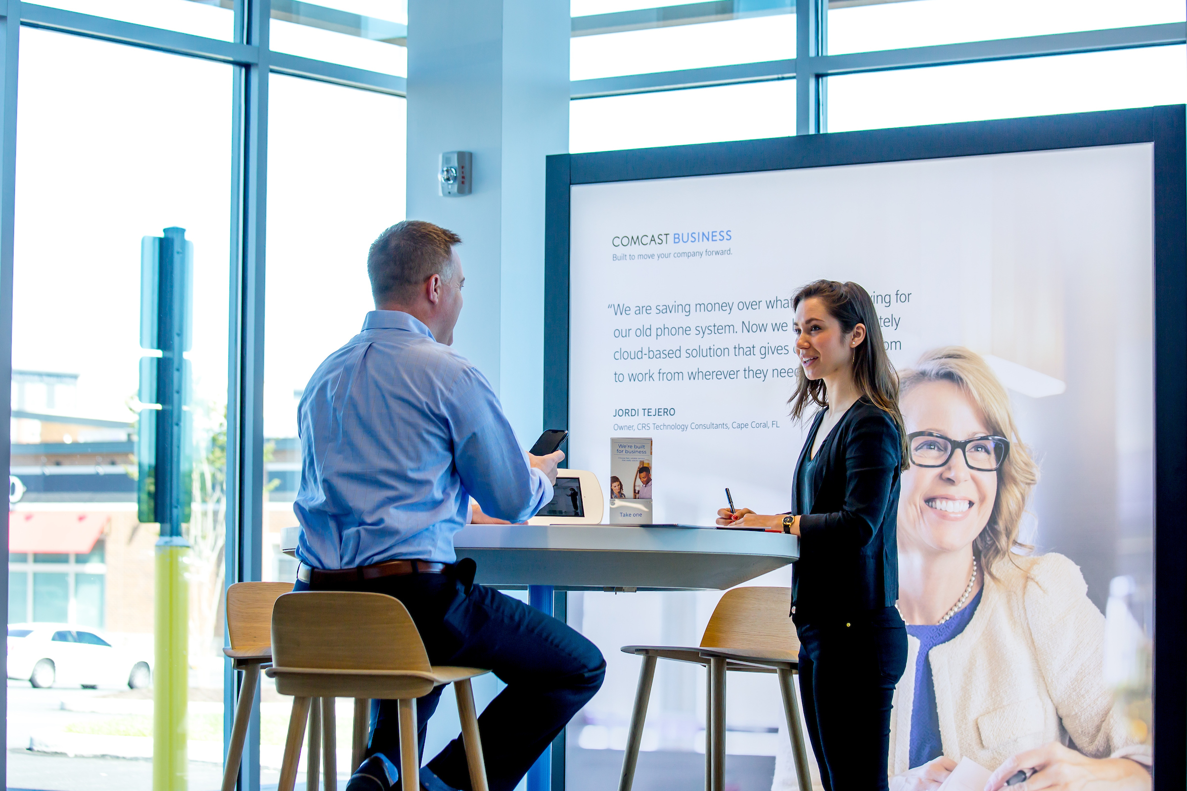 Customer in a Comcast store talking about business solutions