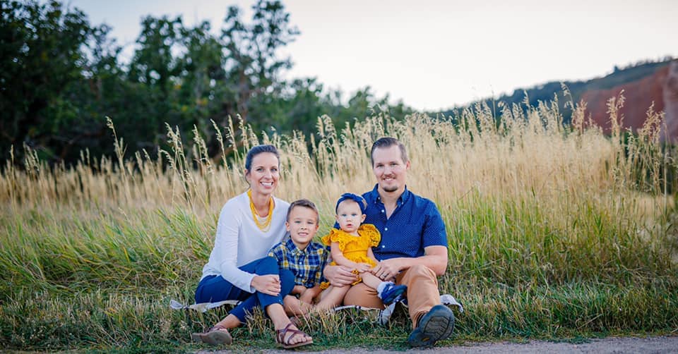 Radicic Family sitting in field