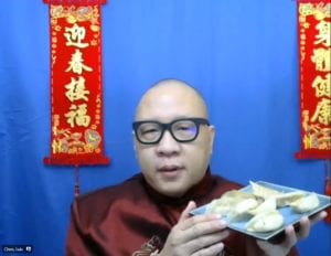 Man holding plate of dumplings during Lunar New Year