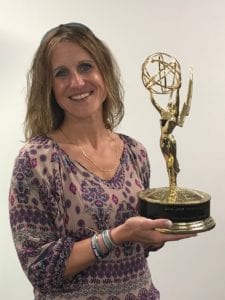 Comcast employee holding an Emmy Award