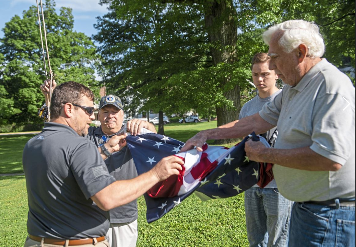 Comcast employees folding American flag