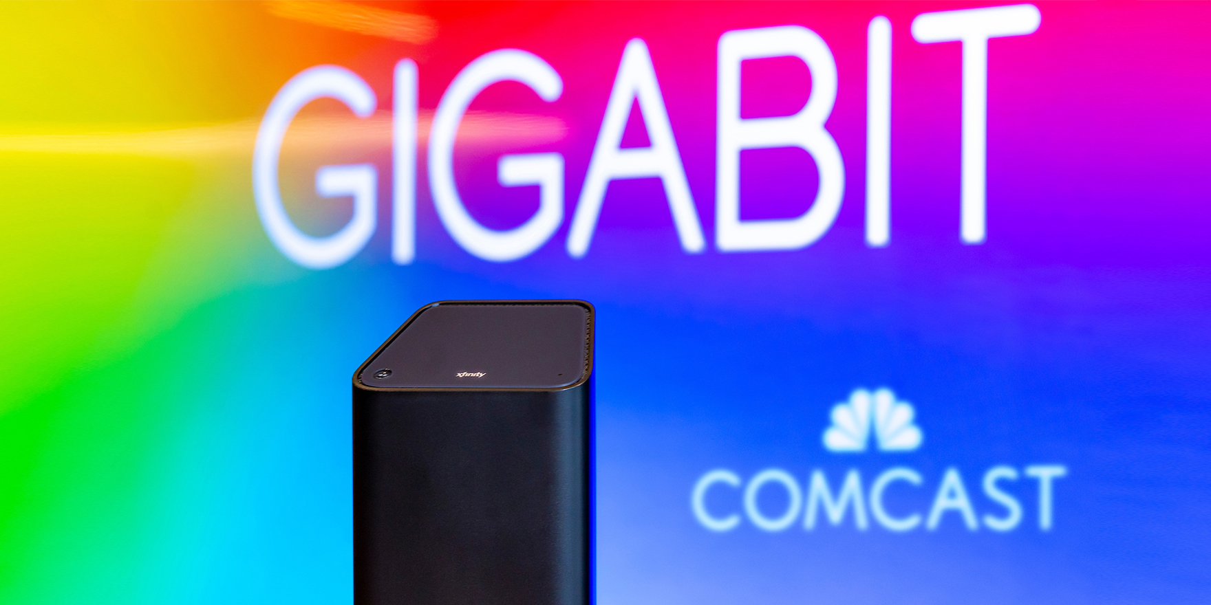 Xfinity gateway with Comcast logo and "Gigabit" in background