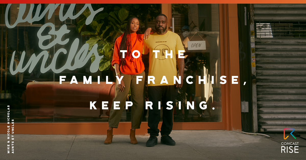 Business owners standing in front of their storefront