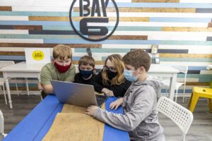 children working on a laptop together