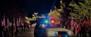 Police car escorting bus transporting military veterans