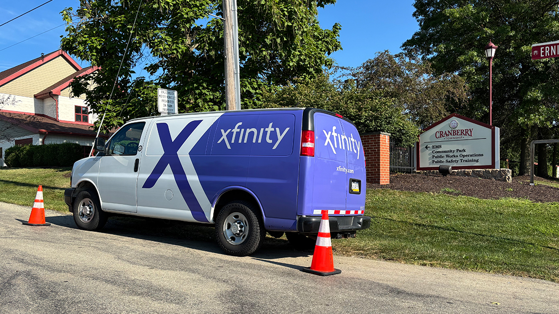 Xfinity van parked on a residential street.